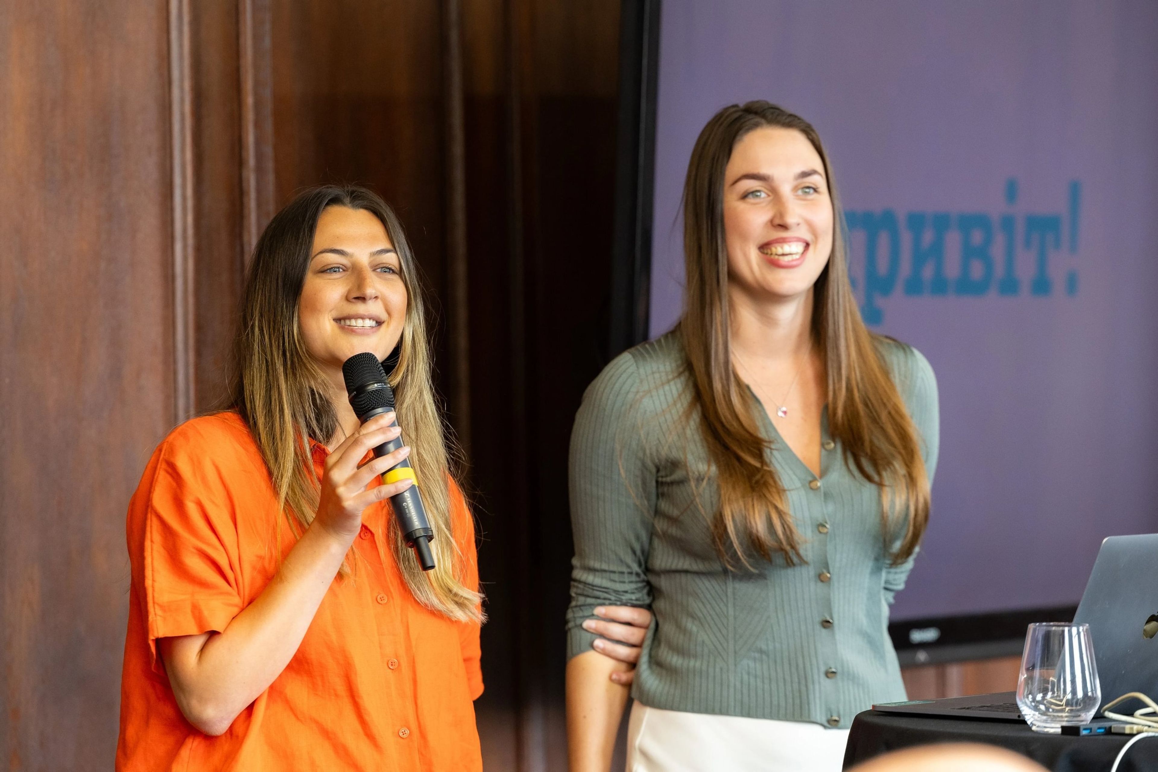 two women next to each other delivering a presentation