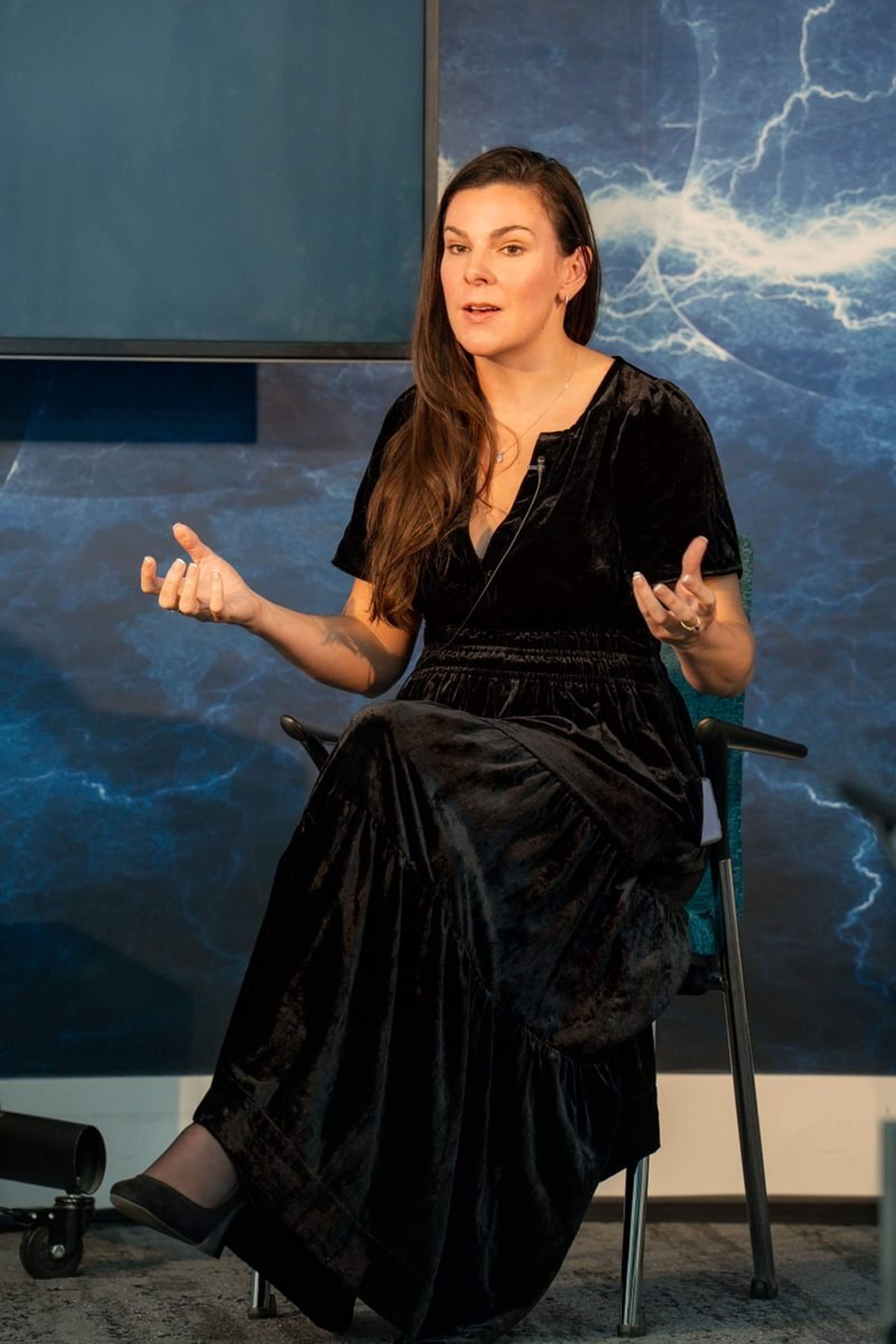 Laura Gilbert addressing the audience sat on a chair