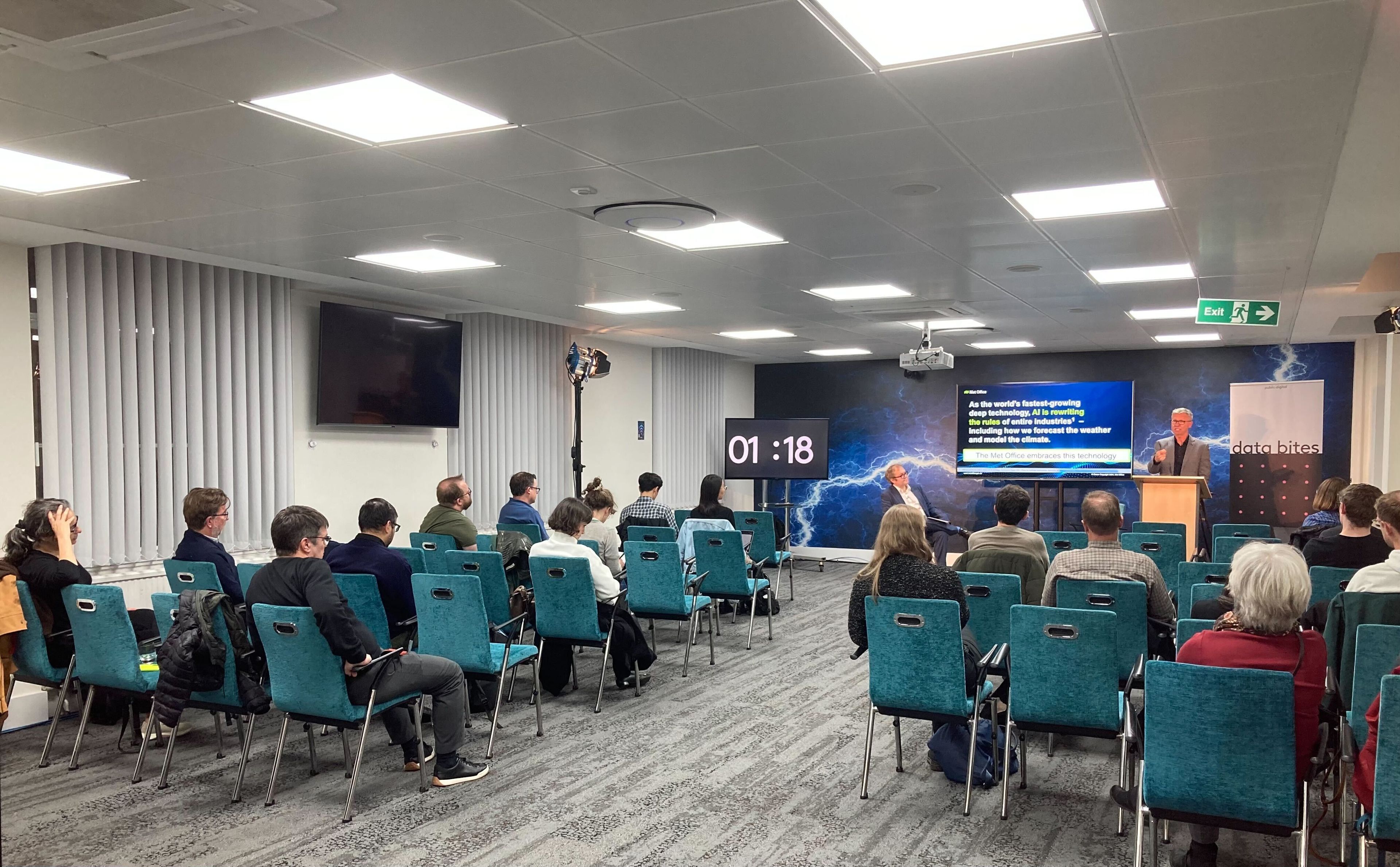 People sitting across the room listening to a Data Bites speaker