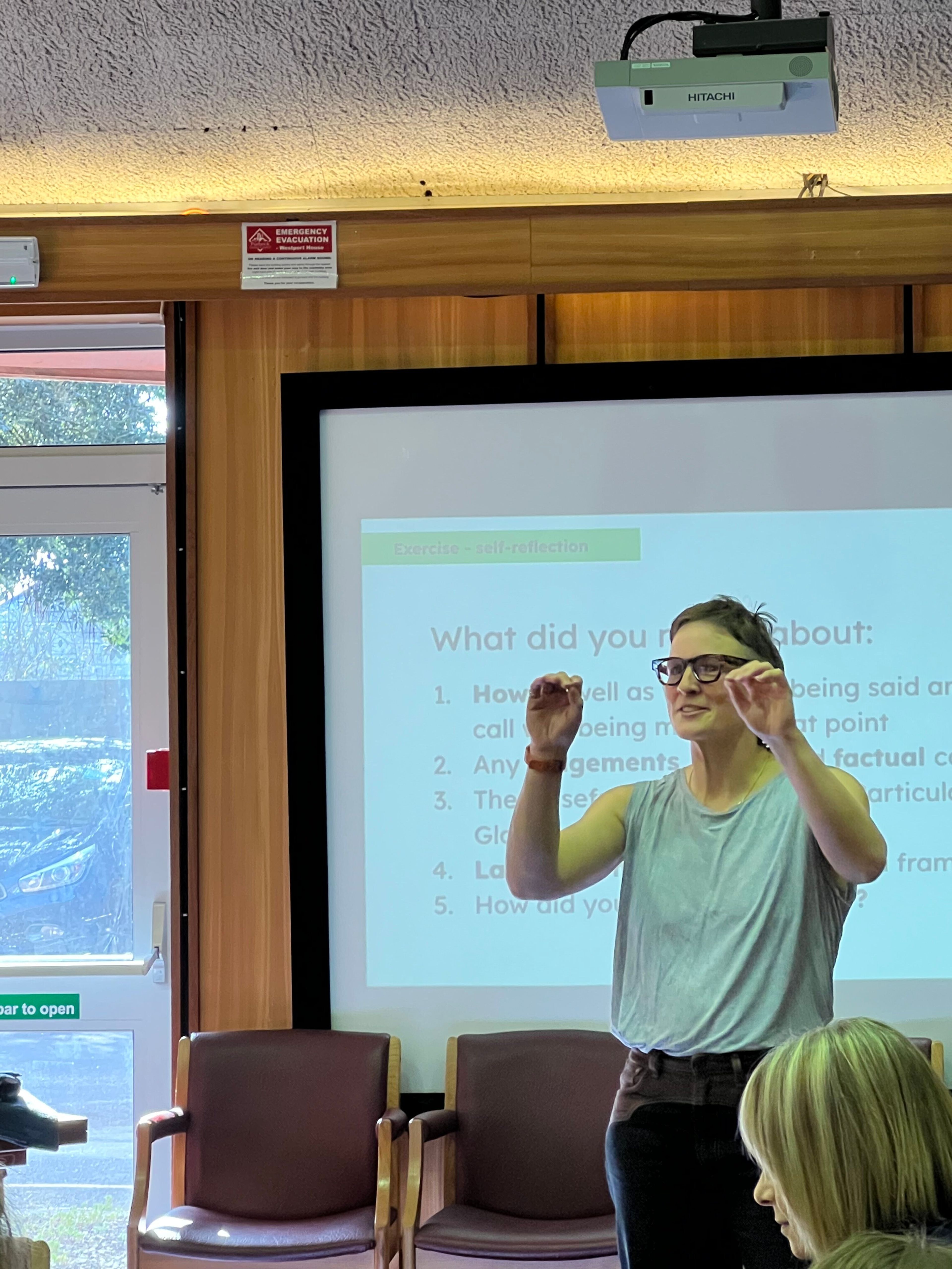 A speaker addresses a room