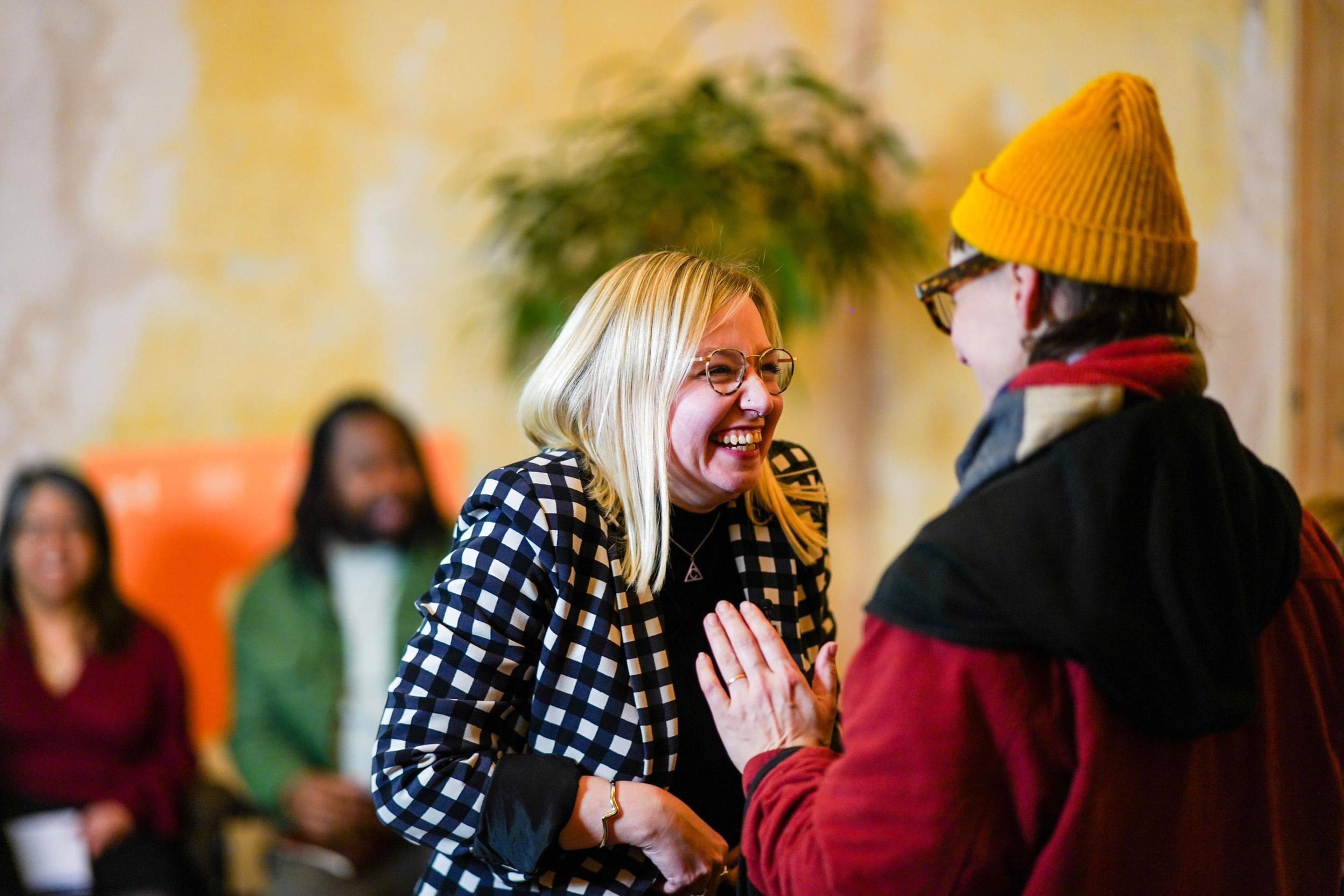 Two women attendees catch up during a break at a conference