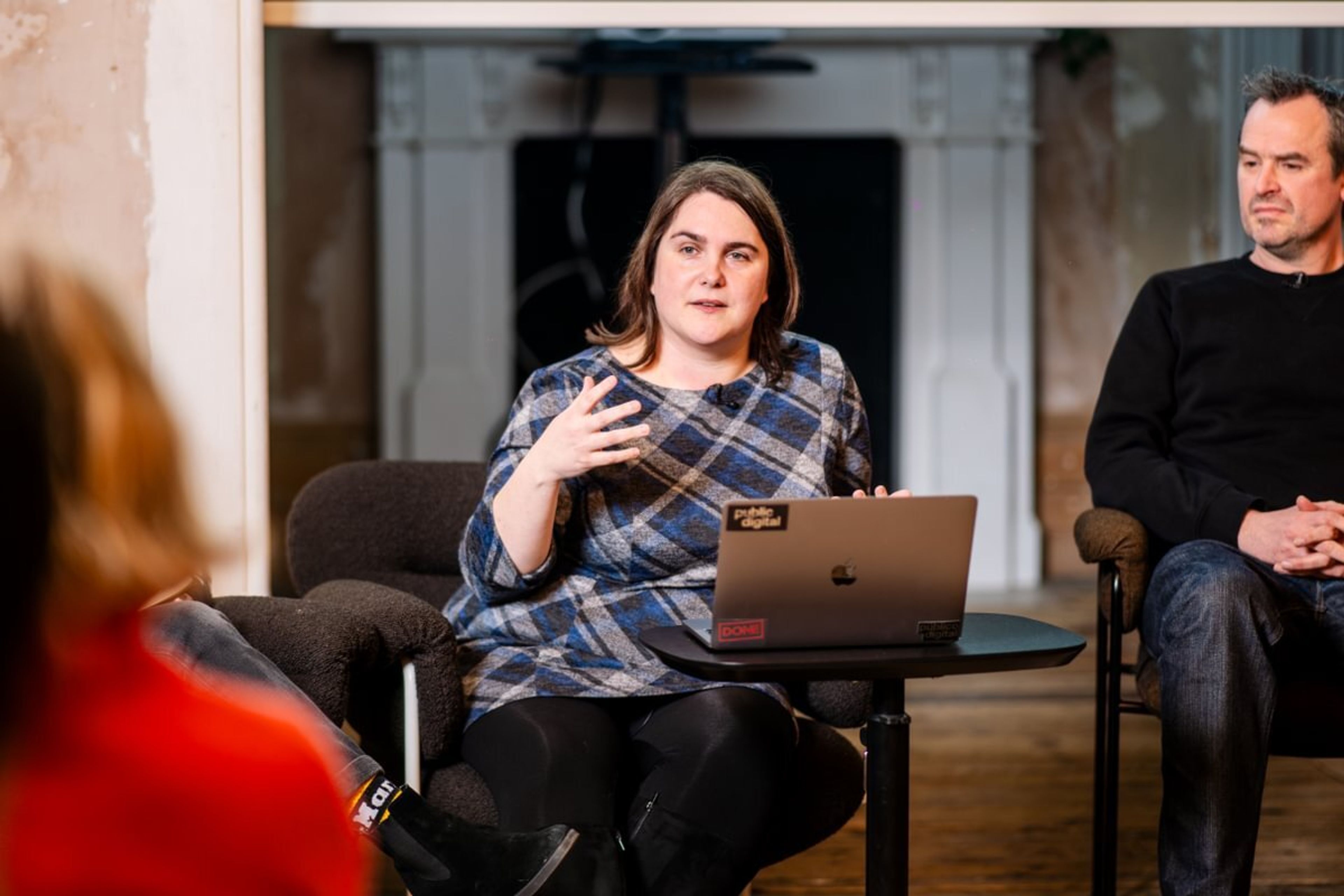 A woman is addressing the audience as part of a panel