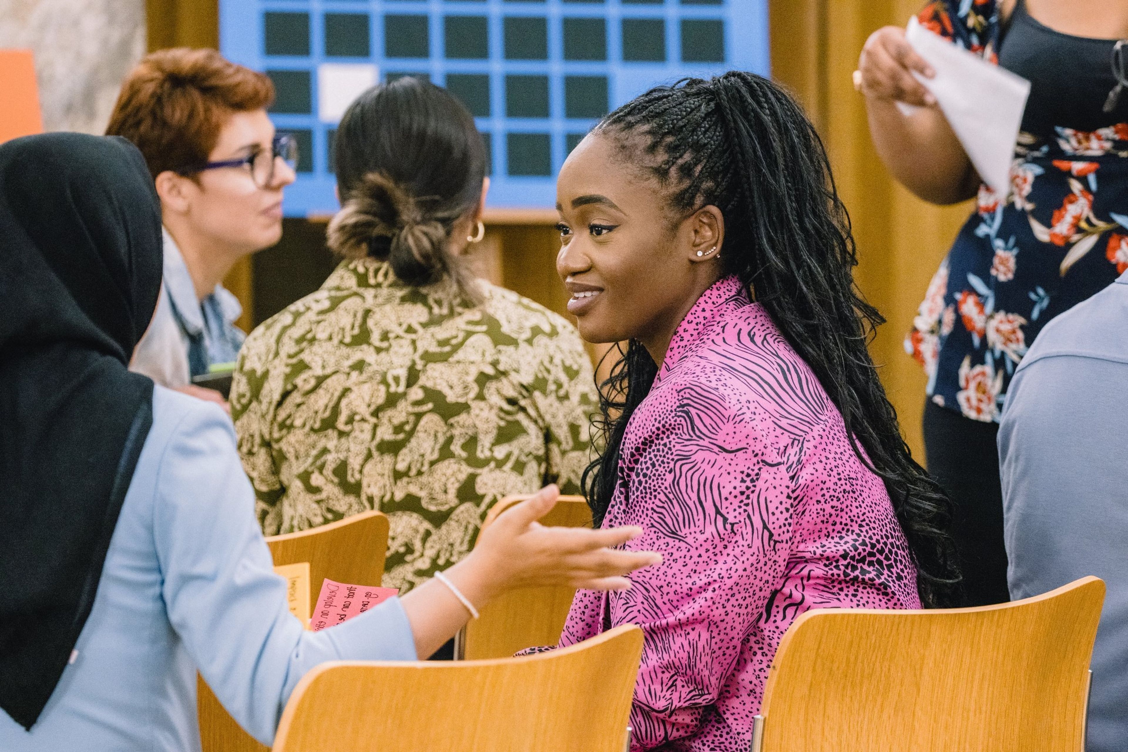 Two women speak to each other during the break of a conference