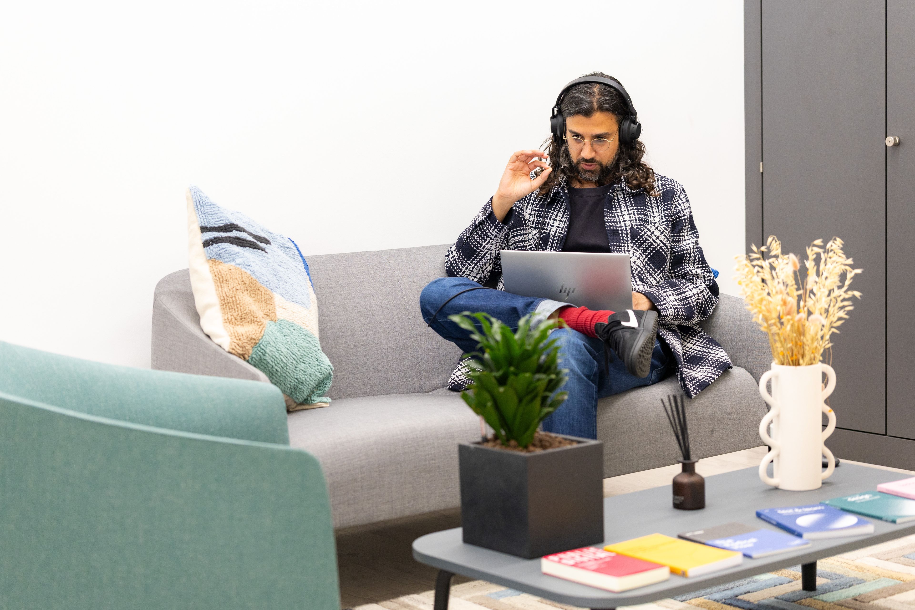 A photo of PD's Holborn office, featuring a member of staff using a laptop,