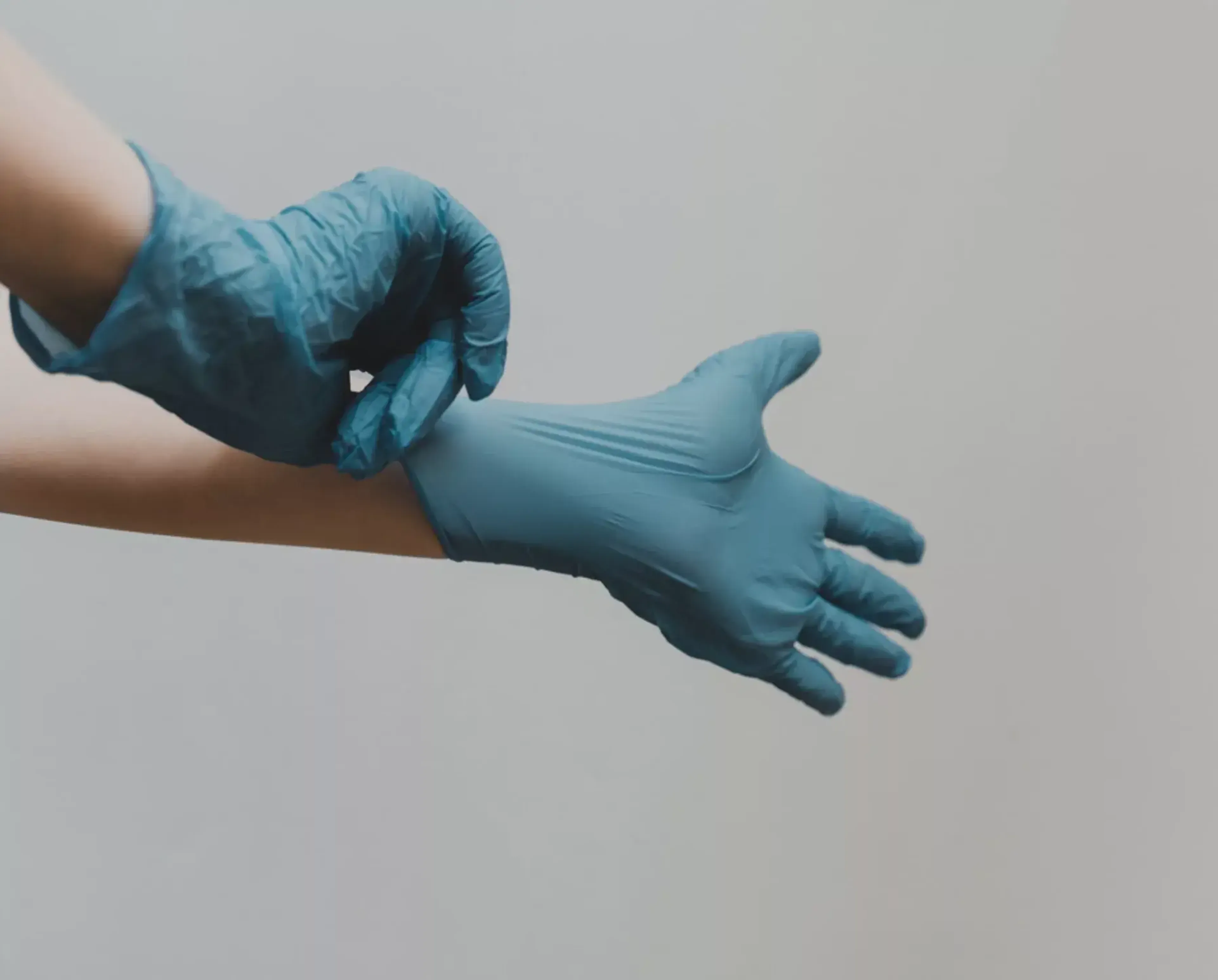 Hands with latex gloves - photo by Clay Banks on Unsplash