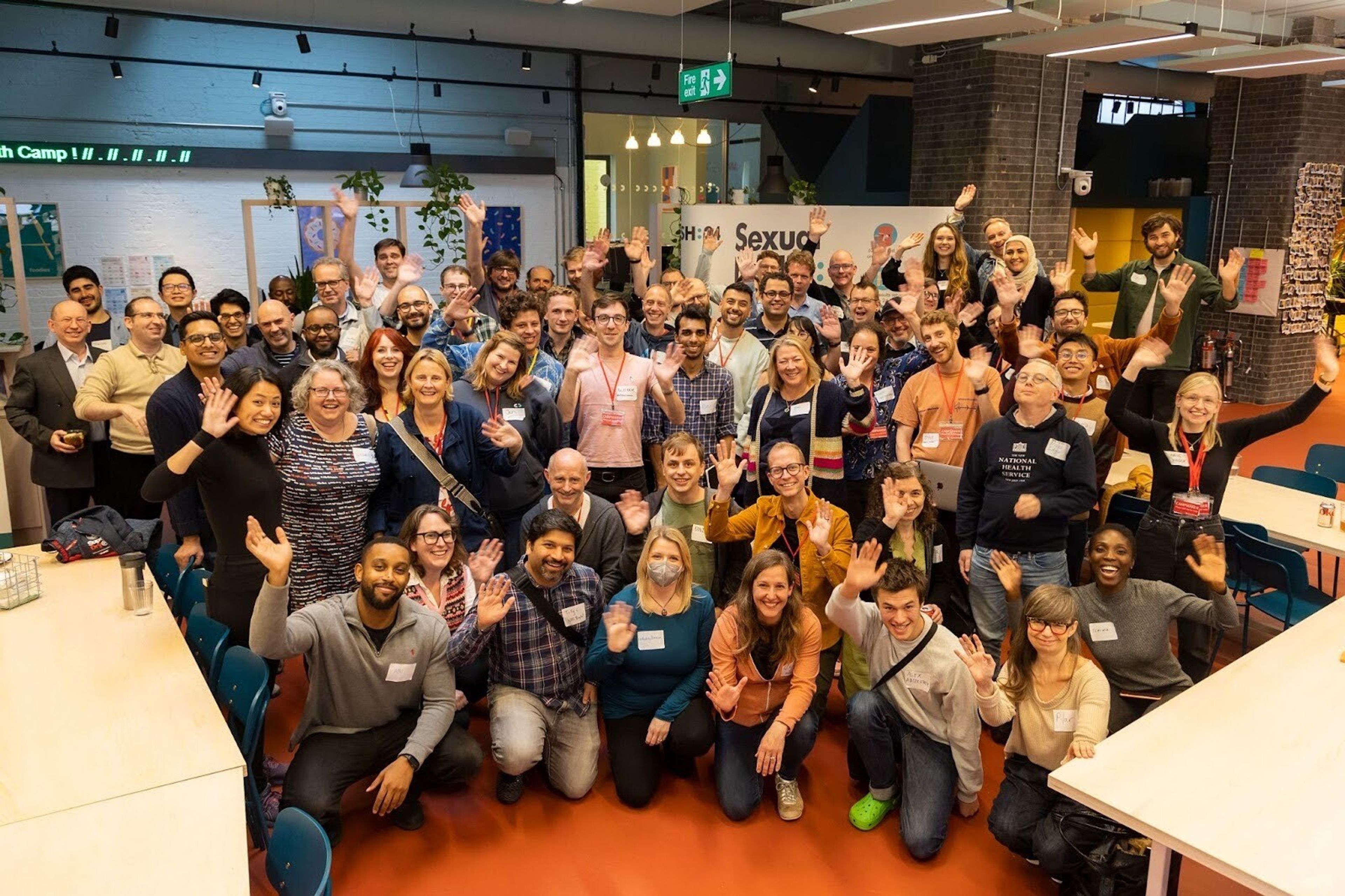 A large group of conference attendants pose for a group picture