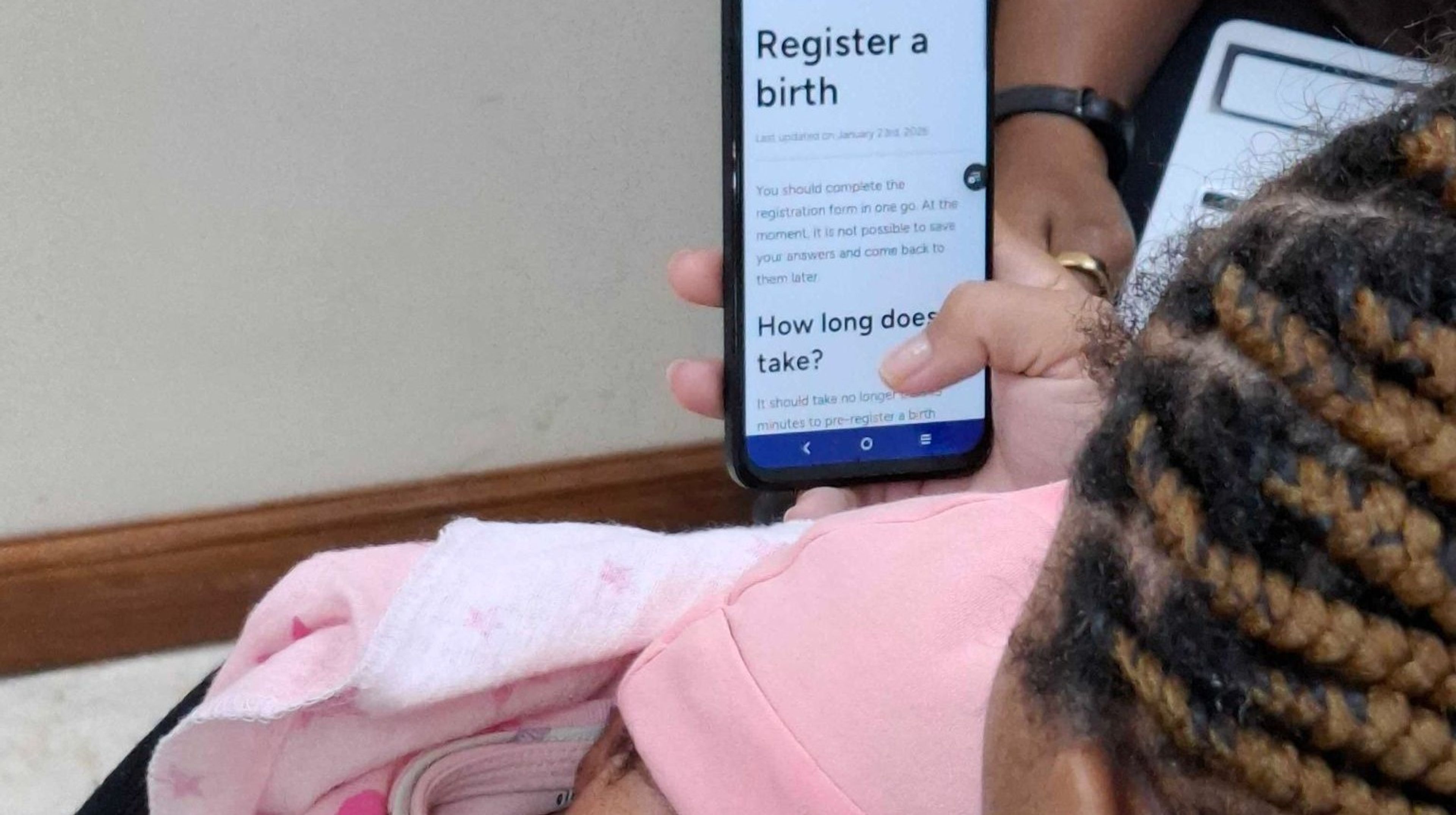 A new mother using our digital birth registration journey