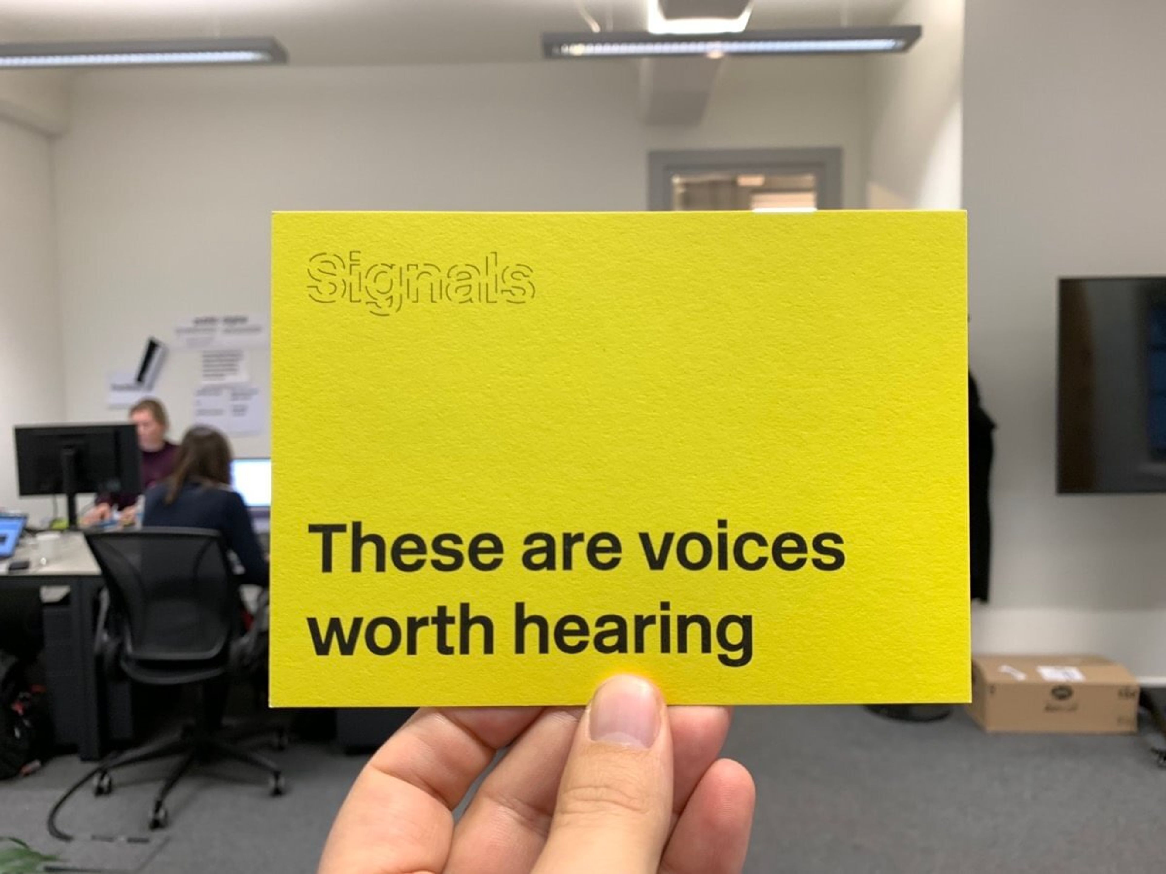 A postcard reads "these are voices worth hearing"